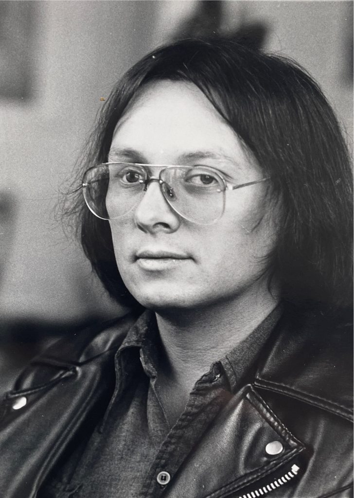 Craig Strete wearing glasses and a leather jacket